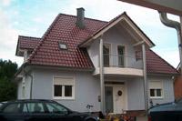 Hausbau Massivhaus in Telgte (Warendorf), Walmdach, 4 Giebel, rundes Fenster, Säulen, Balkon, Spitzbodenausbau, Kamin
