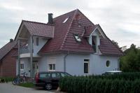 Hausbau Massivhaus in Telgte (Warendorf), Walmdach, 4 Giebel, rundes Fenster, Säulen, Balkon, Spitzbodenausbau, Kamin
