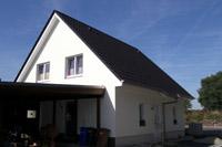 Putzbau in Lengerich (Hasbergen, Lienen), thermische Solaranlage, Dreifachverglasung, Giebel mit Satteldach, Massivbau